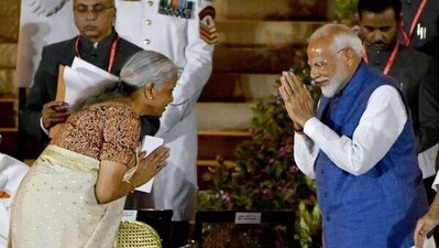 Nirmala Sitharaman greets Prime Minister Narendra Modi after swearing in as Cabinet Minister on June 9.
