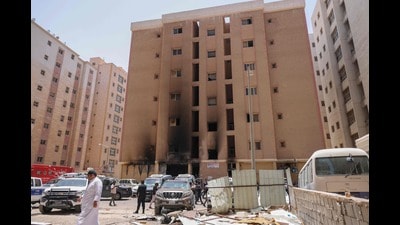 People walk past a building which was ingulfed by fire, in Kuwait City, on June 12, 2024. More than 35 people were killed and dozens injured in a building fire in an area heavily populated with foreign workers in Kuwait, the interior ministry said. (Photo by Yasser Al-Zayyat / AFP) (AFP) People walk past a building which was ingulfed by fire, in Kuwait City, on June 12, 2024. More than 35 people were killed and dozens injured in a building fire in an area heavily populated with foreign workers in Kuwait, the interior ministry said. (Photo by Yasser Al-Zayyat / AFP) (AFP)
