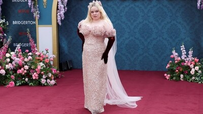 Nicola's hand-beaded blush pink Rodarte gown features an off-the-shoulder neckline with a scalloped design, a figure-hugging silhouette, and a floor-length hem. She styled the ensemble with win red-coloured Opera velvet gloves and a blush pink tulle veil accessorising her centre-parted loose locks. She also wore an Artists4Ceasefire pin with her ensemble.&nbsp; (REUTERS)