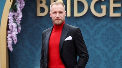 Sam Phillips, who plays the role of Lord Debling, attended the launch of 'Bridgerton' Season 3 Part 2 in London. He wore a crisp midnight black suit and a red turtleneck sweater.&nbsp; (REUTERS)