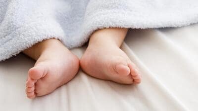 While sleeping, the infant vomited and choked on the milk. On finding the baby unresponsive, her shocked parents rushed her to the Phase 6 civil hospital in Mohali, where doctors declared her dead. (Getty Images/Blend Images)