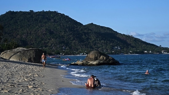 People relax on the Lamai beach on Koh Samui island in the southern Thai province of Surat Thani. (AFP)