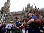 Two men play bagpipes at the 'Marienplatz' square before a Group A match between Germany and Scotland at the Euro 2024 soccer tournament in Munich, Germany, Friday, June 14, 2024. Tourism surge expected in Germany with Euro 2024 Football Championship 