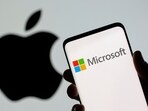 Microsoft logo is seen on the smartphone in front of displayed Apple logo in this illustration. Since January, this marks the first time that Apple closed with a higher market value than Microsoft. 