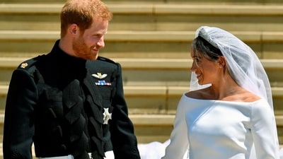 Prince Harry and Meghan Markle walk down the steps after their wedding. (AP) Prince Harry and Meghan Markle walk down the steps after their wedding. (AP)