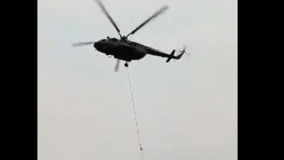 IAF Mi17 V5 helicopter dousing fire at the Binsar Wildlife Sanctuary in Uttarakhand on Friday (Twitter/ video screengrab) IAF Mi17 V5 helicopter dousing fire at the Binsar Wildlife Sanctuary in Uttarakhand on Friday (Twitter/ video screengrab)