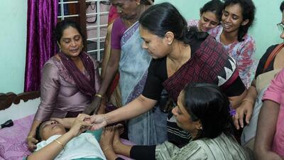 Kerala health minister Veena George consoles the mother of Akash Sasidharan Nair, one of the victims of a fire that broke out in a building housing foreign workers in Kuwait, at Pathanamthitta district of Kerala (REUTERS)