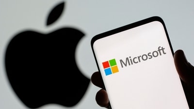 Microsoft logo is seen on the smartphone in front of displayed Apple logo in this illustration. Since January, this marks the first time that Apple closed with a higher market value than Microsoft. (Reuters)