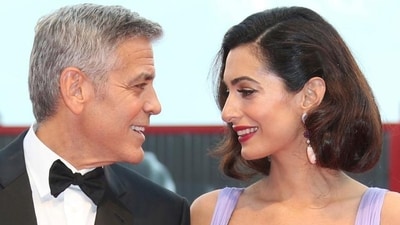 George Clooney, left, and his wife Amal Clooney pose for photographers upon arrival at the premiere of the film Suburbicon during the 74th edition of the Venice Film Festival in Venice, Italy.(Joel Ryan/Invision/AP) George Clooney, left, and his wife Amal Clooney pose for photographers upon arrival at the premiere of the film Suburbicon during the 74th edition of the Venice Film Festival in Venice, Italy.(Joel Ryan/Invision/AP)