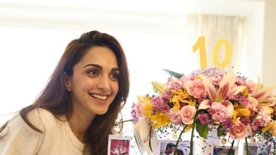 Kiara posed beside a beautiful decoration at home which had several postcards modelled on the posters of her film, whereas a huge bouquet of roses was placed at the centre. 