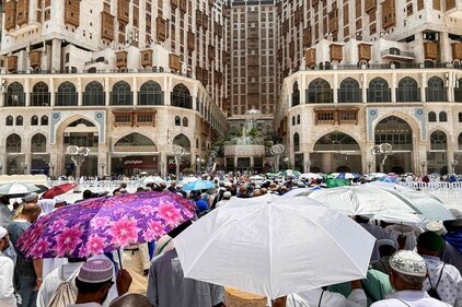 Muslim worshippers shade themselves with umbrellas as they walk near the Grand Mosque in Saudi Arabia's holy city of Mecca. (AFP) Muslim worshippers shade themselves with umbrellas as they walk near the Grand Mosque in Saudi Arabia's holy city of Mecca. (AFP)