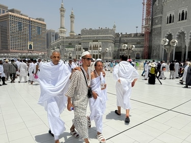 Two blind pilgrims preform Hajj with the help of their guide outside of the Grand Mosque during the annual pilgrimage in Mecca. (AP) Two blind pilgrims preform Hajj with the help of their guide outside of the Grand Mosque during the annual pilgrimage in Mecca. (AP)