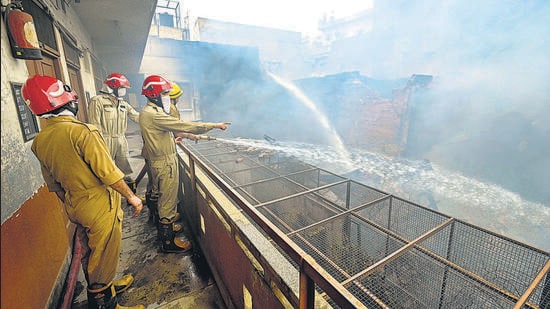 Firefighters continue to douse the fire a day after it broke out at the Marwari Katra market, in Chandni Chowk on Friday. (Raj K Raj/HT Photo)