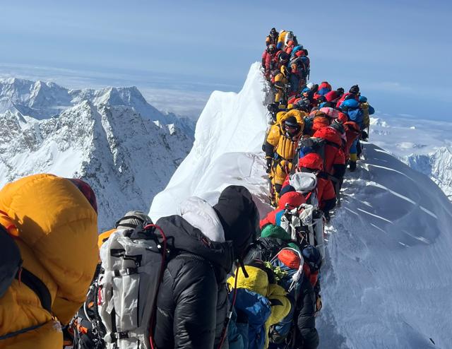 How heavily trafficked is Everest? When part of an ice cornice collapsed in May, photographs offered an indication, as climbers and guides were forced to queue and wait to pass between Hillary Step and the South Summit. (Getty Images)