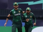  Pakistan's Babar Azam celebrates with Shaheen Shah Afridi after taking the wicket of India's Rishabh Pant 