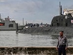 Russian Marines standing on top of the Russian nuclear-powered submarine Kazan (R), part of the Russian naval detachment visiting Cuba. (Photo by YAMIL LAGE / AFP)