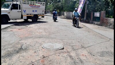 Commuters pass through a broken road in Upkar Nagar in Ludhiana on Saturday. (Manish/HT) Commuters pass through a broken road in Upkar Nagar in Ludhiana on Saturday. (Manish/HT)