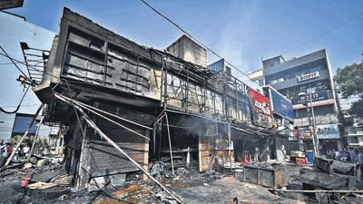 Fire fighters seen cooling down the buildings after a fire gutted inside the shops of C Block Market in early hours of the morning at Vasant Vihar on Saturday. (Sanchit Khanna/HT) Fire fighters seen cooling down the buildings after a fire gutted inside the shops of C Block Market in early hours of the morning at Vasant Vihar on Saturday. (Sanchit Khanna/HT)