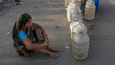 A woman waits to collect drinking water from a tanker of Delhi Jal Board on a hot summer day as water crisis continues, at a slum in Geeta Colony area, in East Delhi, Saturday on June 14, 2024. (PTI) A woman waits to collect drinking water from a tanker of Delhi Jal Board on a hot summer day as water crisis continues, at a slum in Geeta Colony area, in East Delhi, Saturday on June 14, 2024. (PTI)