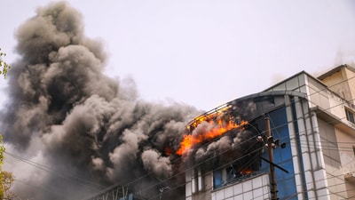 Smoke billows out after a fire broke out in two companies in Noida on Saturday, June 15, 2024. (PTI) Smoke billows out after a fire broke out in two companies in Noida on Saturday, June 15, 2024. (PTI)