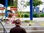 Evidence markers indicate the position of spent shell casings following a mass shooting at the Brooklands Plaza Splash Pad in Rochester Hills, Michigan, U.S. June 15, 2024.  