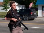 An officer with the Oakland County Sheriff's Department secures the scene of a shooting at the Brooklands Plaza Splash Pad, Saturday, June 15, 2024, in Rochester Hills, Mich. (Katy Kildee, The Detroit News/Detroit News via AP)