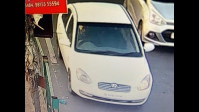 A CCTV grab of a gang member moving in a stolen Hyundai Verna in Ludhiana. (HT) A CCTV grab of a gang member moving in a stolen Hyundai Verna in Ludhiana. (HT)