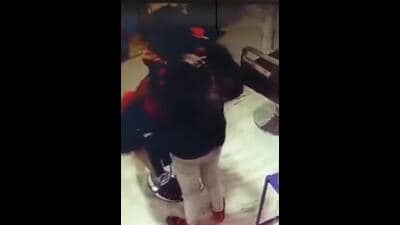 A screen grab from a viral video showing a barber giving spit massage (sourced) A screen grab from a viral video showing a barber giving spit massage (sourced)