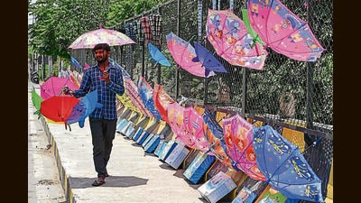 A vendor selling umbrellas waits for customers on a hot summer day in Amritsar on Sunday. (AFP)