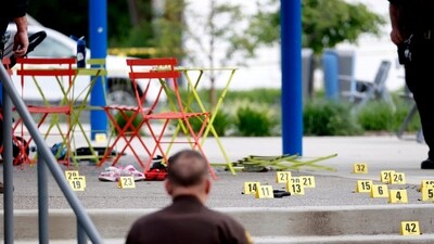 Evidence markers indicate the position of spent shell casings following a mass shooting at the Brooklands Plaza Splash Pad in Rochester Hills, Michigan, U.S. June 15, 2024. (via REUTERS)