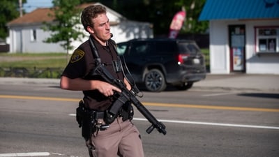 An officer with the Oakland County Sheriff's Department secures the scene of a shooting at the Brooklands Plaza Splash Pad, Saturday, June 15, 2024, in Rochester Hills, Mich. (Katy Kildee, The Detroit News/Detroit News via AP) (AP) An officer with the Oakland County Sheriff's Department secures the scene of a shooting at the Brooklands Plaza Splash Pad, Saturday, June 15, 2024, in Rochester Hills, Mich. (Katy Kildee, The Detroit News/Detroit News via AP) (AP)