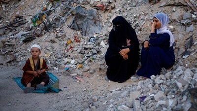 Palestinians attend Eid al-Adha prayers by the ruins of al-Al Rahma mosque destroyed by Israeli air strikes, amid the Israel-Hamas conflict. (Reuters)