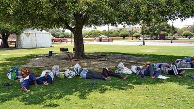 Vendors take rest in the shade of a tree on a hot summer day in New Delhi on Sunday. (PTI) Vendors take rest in the shade of a tree on a hot summer day in New Delhi on Sunday. (PTI)