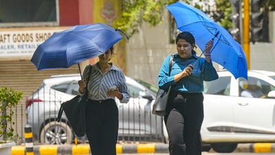 New Delhi: Women cover themselves under umbrellas during heatwave, in New Delhi, Saturday, June 15, 2024. (PTI) New Delhi: Women cover themselves under umbrellas during heatwave, in New Delhi, Saturday, June 15, 2024. (PTI)