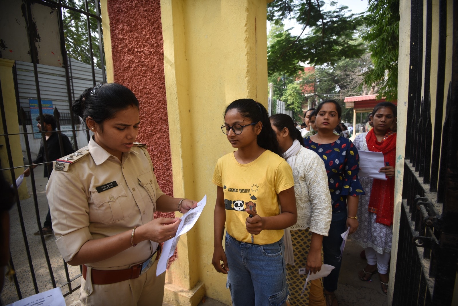 Security personnel check aspirants'' documents outside Patna's Magadh Mahila College examination center. (Photo by Santosh Kumar)
