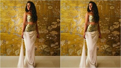 Radhika stole the spotlight at the Ambani family's Toga party in a stunning bespoke gold top and skirt by Grace Ling. The outfit featured a golden aluminum breastplate crafted using advanced 3D carving, sculpting, and printing techniques. (Instagram) Radhika stole the spotlight at the Ambani family's Toga party in a stunning bespoke gold top and skirt by Grace Ling. The outfit featured a golden aluminum breastplate crafted using advanced 3D carving, sculpting, and printing techniques. (Instagram)
