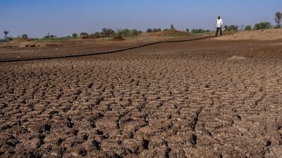 A farmer walks on a lake that has dried up due to drought outside Beed, India (Rafiq Maqbool/AP Photo) A farmer walks on a lake that has dried up due to drought outside Beed, India (Rafiq Maqbool/AP Photo)