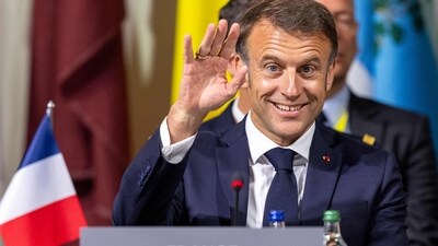 France's President Emmanuel Macron waves as he attends the plenary session of the Summit on peace in Ukraine. (AFP) France's President Emmanuel Macron waves as he attends the plenary session of the Summit on peace in Ukraine. (AFP)