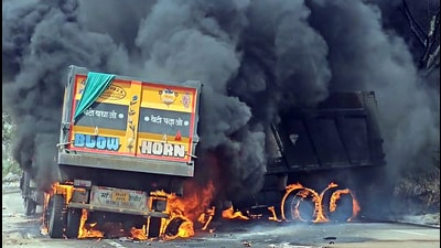 Smoke and flames billow out of the trucks that caught fire following an accident, in Jhajjar on Monday. (ANI)