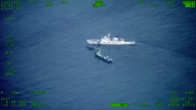 A Philippines supply boat, center, sails near a Chinese coast guard ship, top, and a Chinese militia vessel off Second Thomas Shoal, locally called Ayungin Shoal, at the disputed South China Sea. (File) (AP) A Philippines supply boat, center, sails near a Chinese coast guard ship, top, and a Chinese militia vessel off Second Thomas Shoal, locally called Ayungin Shoal, at the disputed South China Sea. (File) (AP)