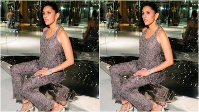 Skhola took over the night festivities in a sleek grey silk jumpsuit featuring sleeveless details, bodycon patterns and intricate work in grey resham threads. In diamond drop earrings and white box heels, Shloka kept it chic and minimal. (Instagram/@ambani_update) Skhola took over the night festivities in a sleek grey silk jumpsuit featuring sleeveless details, bodycon patterns and intricate work in grey resham threads. In diamond drop earrings and white box heels, Shloka kept it chic and minimal. (Instagram/@ambani_update)