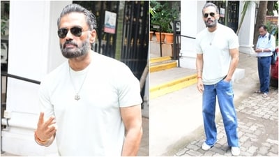 Suniel Shetty embraced the laidback, suave aesthetic for his OOTD as he stepped out in Mumbai. The actor wore a classic white T-shirt and baggy denim jeans styled with white sneakers, aviators, and a sleek silver chain. The highlight of his day-out look was the salt-and-pepper hairdo and beard. (Instagram) Suniel Shetty embraced the laidback, suave aesthetic for his OOTD as he stepped out in Mumbai. The actor wore a classic white T-shirt and baggy denim jeans styled with white sneakers, aviators, and a sleek silver chain. The highlight of his day-out look was the salt-and-pepper hairdo and beard. (Instagram)