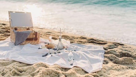 Sunset beach picnic: There are few places that can match the captivating charm of a beach at dusk. Fill a basket with delicacies such as fresh fruit, handmade cheeses and a chilled bottle of champagne. With the sound of the waves lulling you to sleep, spread out a comfortable blanket on the smooth beach and enjoy a romantic meal as the sun sets. (Pexels)