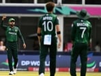 Pakistan's Shaheen Shah Afridi discusses with teamates after challenging the decision of the empire
