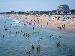 The cool waters of the Atlantic Ocean attract a crowd to Old Orchard Beach, Maine, Tuesday, June 18, 2024. The heat wave that has been hitting much of the United States is now moving into the Northeast. 