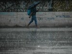 A man carrying an umbrella walks along a street during rainfall in Chennai. (AFP) A man carrying an umbrella walks along a street during rainfall in Chennai. (AFP)