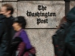 People walk by the One Franklin Square Building, home of The Washington Post newspaper, in downtown Washington.