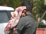 A man covers a child with a scarf during a heatwave, in New Delhi on Saturday, June 15. A man covers a child with a scarf during a heatwave, in New Delhi on Saturday, June 15.