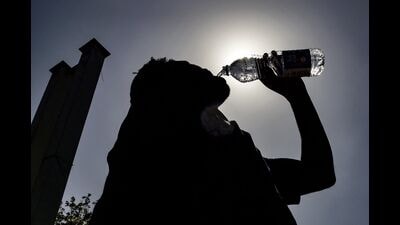 A passenger drinking water is silhouetted against the sun on a hot summer day at Jalandhar Cantonment railway station in Jalandhar on June 11, 2024 amid heatwave. Photo by Shammi MEHRA / AFP) (AFP) A passenger drinking water is silhouetted against the sun on a hot summer day at Jalandhar Cantonment railway station in Jalandhar on June 11, 2024 amid heatwave. Photo by Shammi MEHRA / AFP) (AFP)