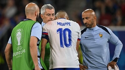 France's forward #10 Kylian Mbappe receives medical treatment (AFP)